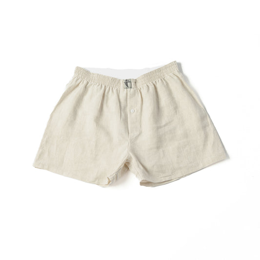 A pair of beige 100% linen men's boxer shorts with a visible elastic waistband.