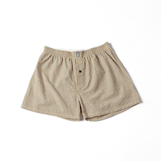 A pair of striped cotton shorts in yellow and black, with a button at the waist.